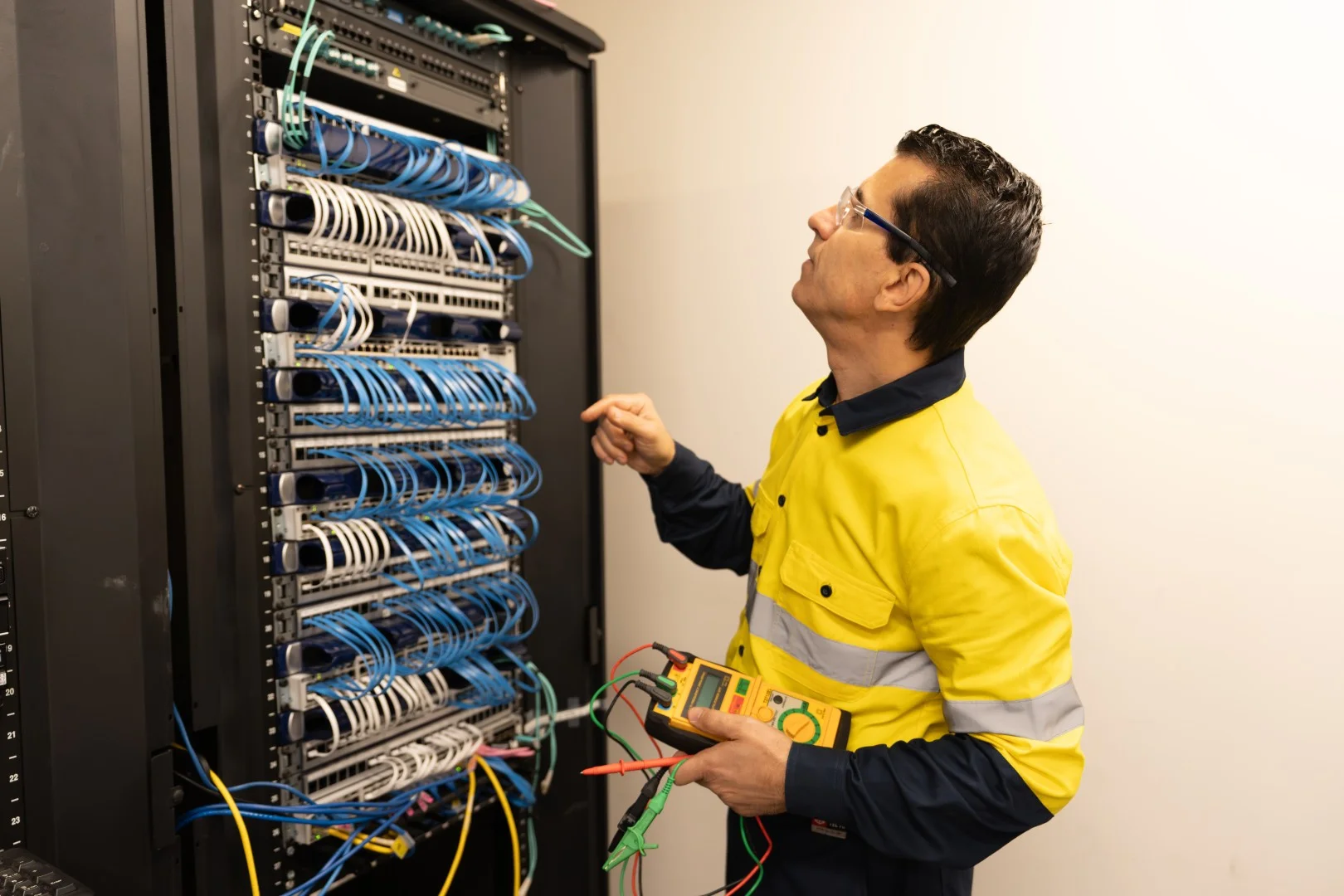 Electrician testing an RCD safety switch at a switchboard
